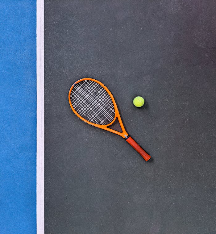 services-02 A tennis racket and ball on a court, emphasizing sports equipment essentials.